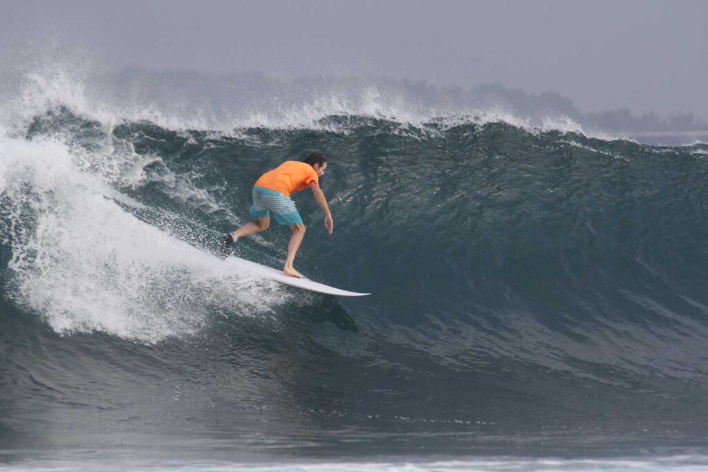 Mark Coulbourne surfing the waves in Indonesia